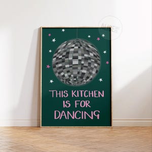 May include: A green poster with a disco ball hanging from the ceiling. The poster says "This kitchen is for dancing" in pink letters.