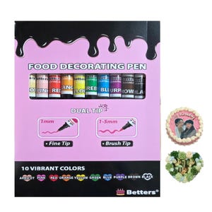 Op de afbeelding: Een roze doos met voedseldecoratiepennen met 10 levendige kleuren. De doos bevat pennen met dubbele punt, met fijne en penseelpunten. De afbeelding toont ook een versierde taart en een bloemenhart.