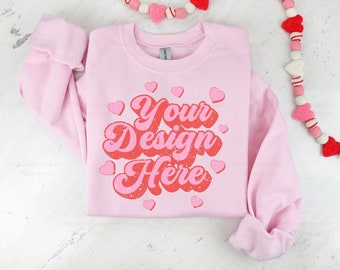 May include: Pink sweatshirt with the text "Your Design Here" in a retro font with red and pink hearts.
