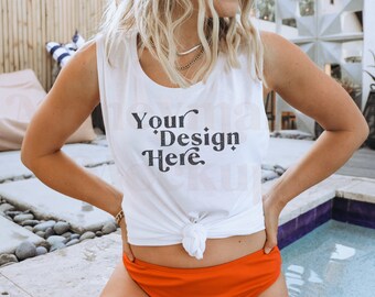 May include: A white sleeveless tank top with the text "Your Design Here" printed on the front. The tank top is tied at the waist and the model is wearing it with red bikini bottoms.