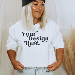 May include: White sweatshirt with long sleeves and the text "Your Design Here" printed in black.