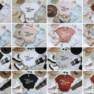May include: A collection of 10 different t-shirt mockups featuring various colors and styles. Each mockup includes a t-shirt, jeans, and accessories like hats, boots, and scarves. The t-shirts all feature the text "Your Design Here" in white.