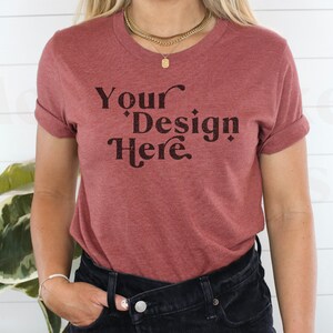 May include: A maroon t-shirt with the text "Your Design Here" in a black retro font.