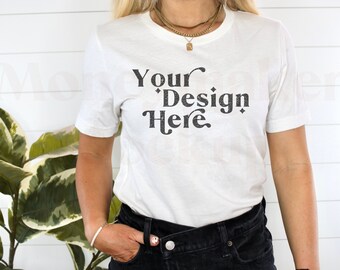 May include: A white t-shirt with the text "Your Design Here" in black lettering. The shirt is being worn by a person with long blonde hair and a gold necklace.