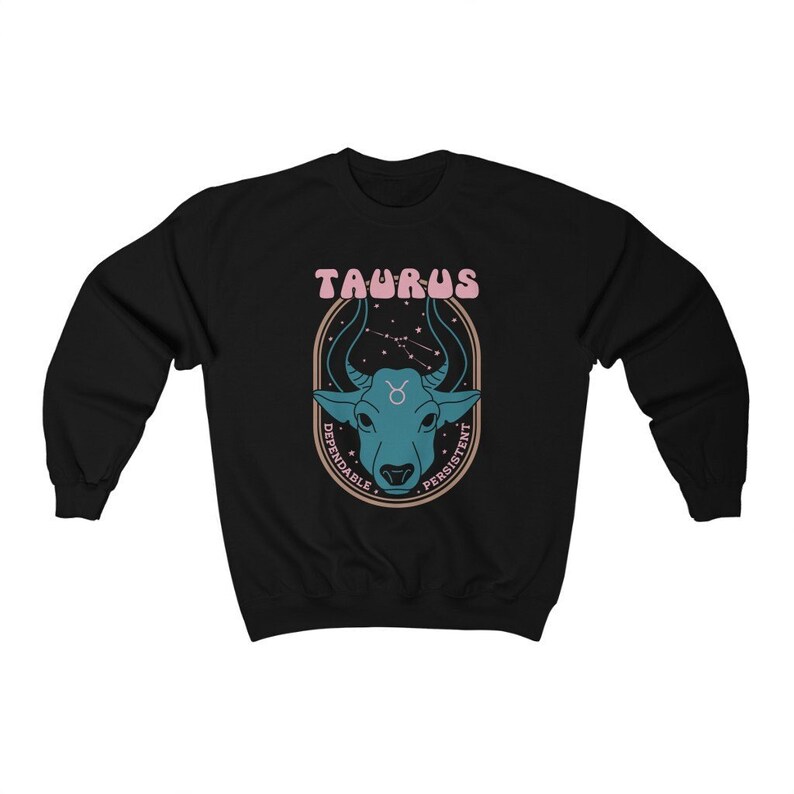 May include: Black sweatshirt with a graphic of a blue bull's head in a circle with the text "Taurus" in pink letters and "Dependable" and "Persistent" written around the circle.