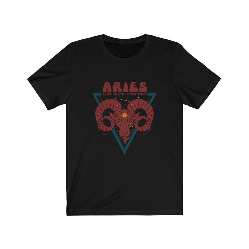 May include: Black t-shirt with a red and white graphic of an Aries zodiac sign. The graphic includes the text "Aries", "Passionate", and "Confident".