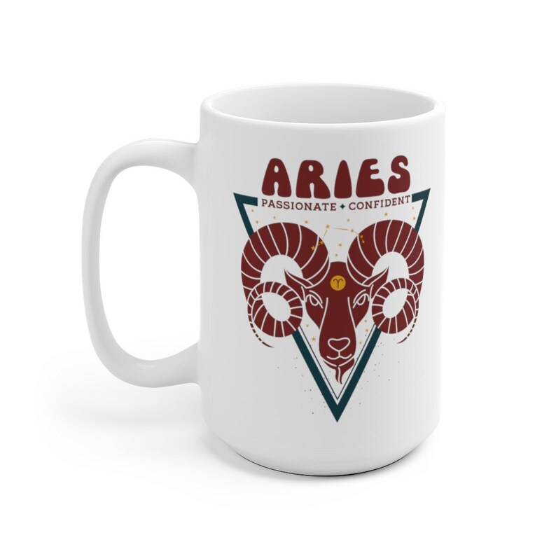 May include: White ceramic mug with a red and white illustration of an Aries zodiac sign with the text "Aries Passionate + Confident" in a triangle.