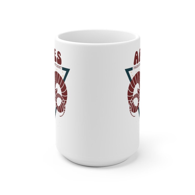 May include: White ceramic mug with a red and blue graphic of an astrological ram with the text "Aries" and "Passionate, Independent" on either side of the ram.