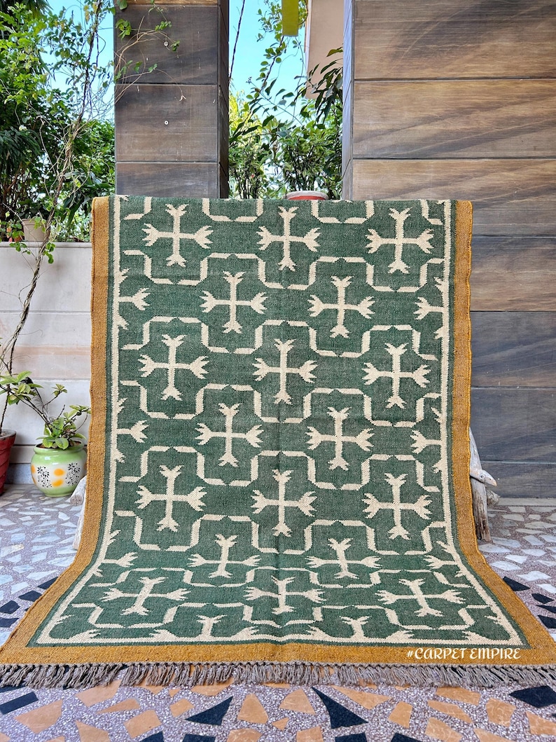 This exquisite handmade flatweave dhurrie combines traditional Navajo patterns with the timeless beauty of Southwestern design, perfect for those who appreciate authentic and vibrant home decor.