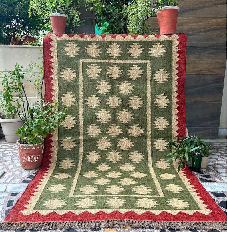 Introduce a blend of cultural elegance and earthy charm to your living space with our Green Kilim Navajo Rug. This exquisite handmade flatweave dhurrie combines traditional Navajo patterns with the timeless beauty of Southwestern design