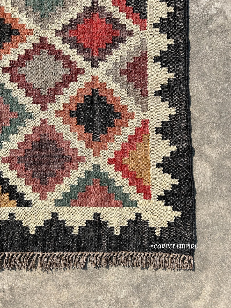 Kilim Area Rug in handwoven jute and wool with bold multicolor diamond lattice pattern — a Jute Wool Rug for boho, farmhouse, and Southwestern interiors.