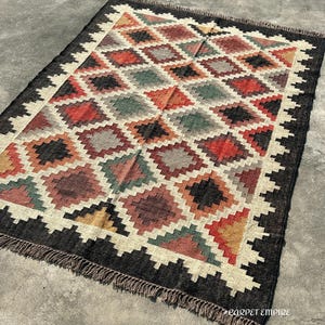 Boho handcrafted Kilim Area Rug in jute and wool blend — multicolor tribal diamond design with hand-knotted fringe.