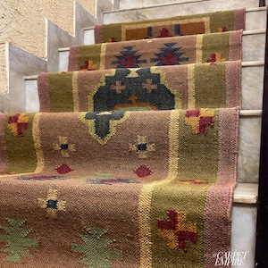 May include: A set of four brown, green, and red patterned jute rugs laid out on a set of stairs. The rugs have a geometric design with a variety of colors and textures.