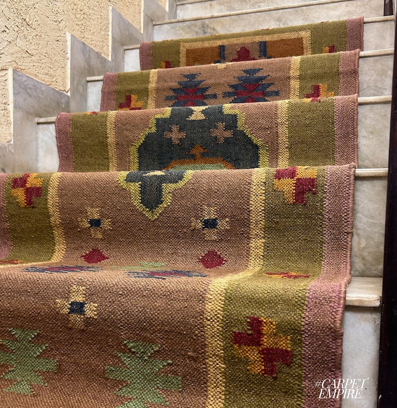 May include: A set of four brown, green, and red patterned jute rugs laid out on a set of stairs. The rugs have a geometric design with a variety of colors and textures.