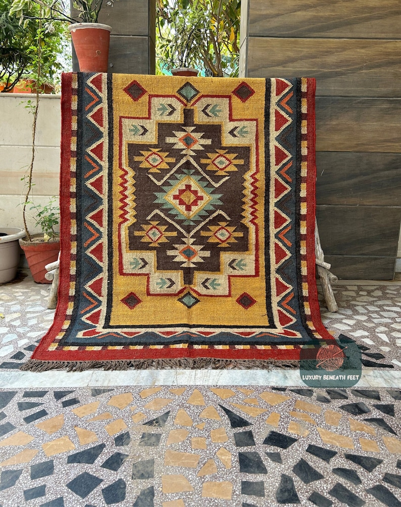 Introducing our exquisite Southwestern Navajo Wool Jute Area Rug, a fusion of timeless tradition and contemporary flair.  this rug features a captivating Vintage Kilim pattern that adds a touch of cultural richness to any space.