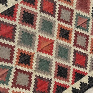 Southwestern-inspired Kilim Area Rug handloomed from jute and wool — earthy multicolor design for boho, tribal, and eclectic homes.