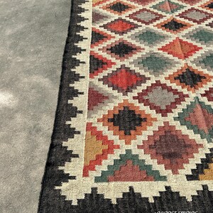 Jute Wool Rug in handwoven kilim weave featuring warm earth tones and black stepped border — a Kilim Area Rug for farmhouse and Mediterranean interiors.
