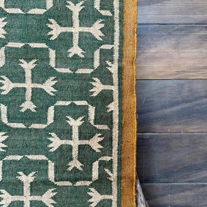 Whether you're styling your living room, bedroom, or outdoor patio, this versatile rug adds warmth, texture, and a unique global appeal.

Designed for high-traffic areas, the Green Kilim Navajo Rug is durable and easy to maintain