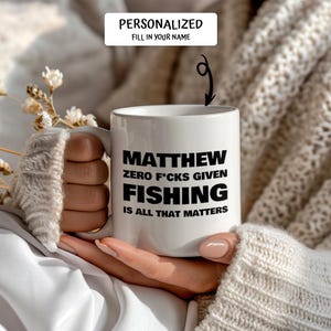 May include: White ceramic mug with the text "MATTHEW ZERO F*CKS GIVEN FISHING IS ALL THAT MATTERS" in black. The mug is personalized with the name "MATTHEW" and the words "FILL IN YOUR NAME" above the mug.