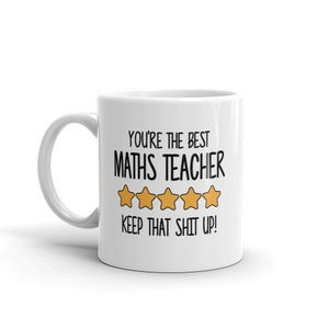 May include: White ceramic mug with a black text that reads "YOU'RE THE BEST MATHS TEACHER" with five gold stars and the text "KEEP THAT SHIT UP!". The mug has a white handle.