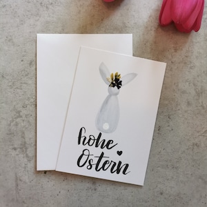 Cartolina con coniglietti da dietro e corona di fiori secchi – auguri di Pasqua, cartolina di Pasqua, Buona Pasqua