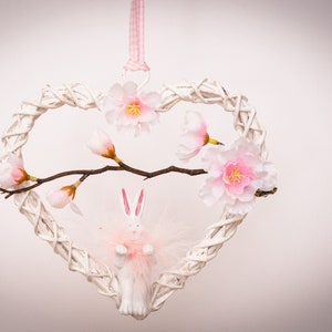 Window decoration, door decoration, hanging heart decoration for Easter with rabbit and flowers to hang. Easter decoration spring pink white rustic country style