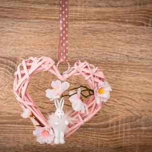 Window decoration, door decoration, hanging heart decoration for Easter with rabbit and flowers to hang. Easter decoration spring pink white rustic country style