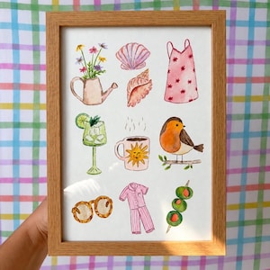 May include: A framed watercolour print featuring nine illustrations: a watering can with flowers, two seashells, a pink dress, a cocktail, a sun-patterned mug, a robin on a branch, round sunglasses, pink pyjamas, and a skewer of three olives.