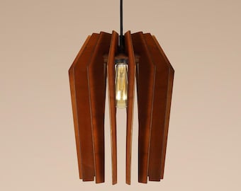 May include: A contemporary pendant light with a geometric wooden shade. The shade is made of vertical, angled wooden slats in a warm brown colour, surrounding a central light bulb. The light hangs from a black cord.