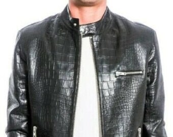 May include: A black leather jacket with a crocodile-embossed pattern. The jacket has a zipper closure and two zippered pockets on the sides.