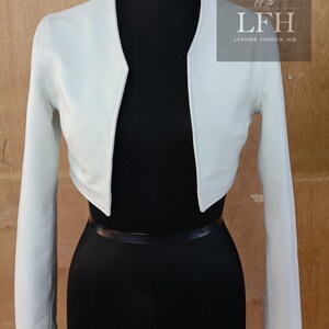 May include: A light green cropped leather jacket with long sleeves. The jacket has a V-neck and is shown on a mannequin. The text "LFH Leather Fashion Hub" is visible on the image.