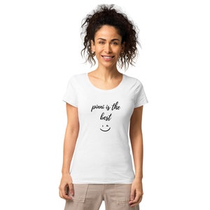 May include: White scoop neck t-shirt with the text "pivvi is the best" in black script and a smiling face graphic. The shirt is made of a soft material.