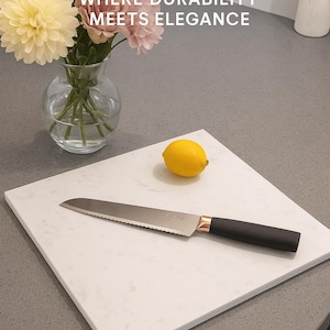 May include: A white quartz cutting board with a serrated knife and a lemon. The knife has a black handle and copper accents. The image includes text that reads "QUARTZIZE" and "WHERE DURABILITY MEETS ELEGANCE."