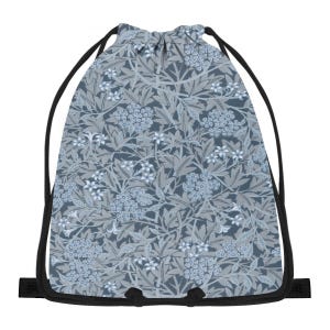 May include: A drawstring bag with a floral pattern in shades of blue and grey. The design features stylized flowers and leaves against a darker background. The bag has black drawstrings and a black base.