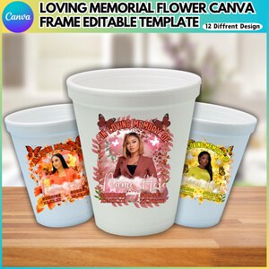 May include: Three white memorial cups with floral and butterfly designs. Each cup features a portrait and the text "In Loving Memory Of," along with "Sunrise" and "Sunset" details. The cups are on a wooden surface.