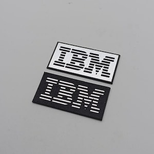 Set of 2 plastic IBM logos in silver or gold
