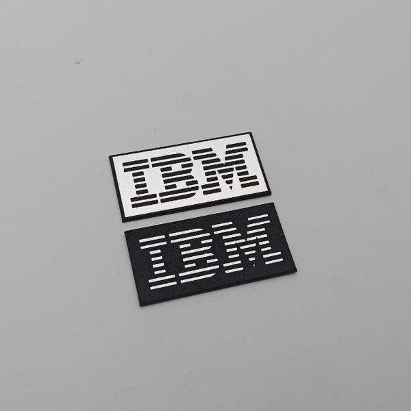 Set of 2 plastic IBM logos in silver or gold