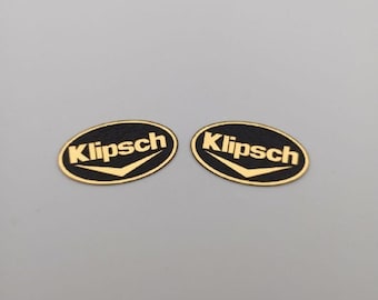 2 pcs. plastic oval badge with Klipsch logo in gold, silver, white