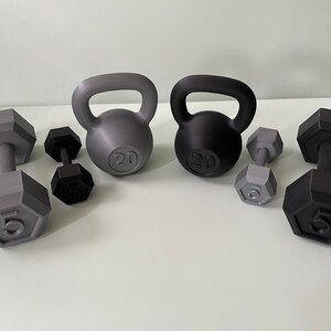 May include: A set of gray and black kettlebells and dumbbells. The kettlebells are labeled "20" and the dumbbells are labeled "5".