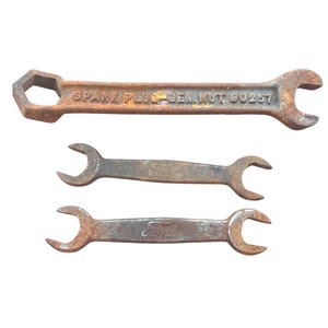 Three Automotive Wrenches; Two Ford Wrenches and Battery & Spark Plug Wrench; Spark Plug Gen. Nut 90257; Ford Double Open End Wrench