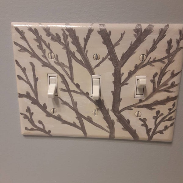 Switchplate cover with tree branch theme.