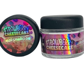 May include: Two glass jars with black lids. The jars contain a white substance and have a holographic label that reads "Strawberry Cheesecake Marshmallow".