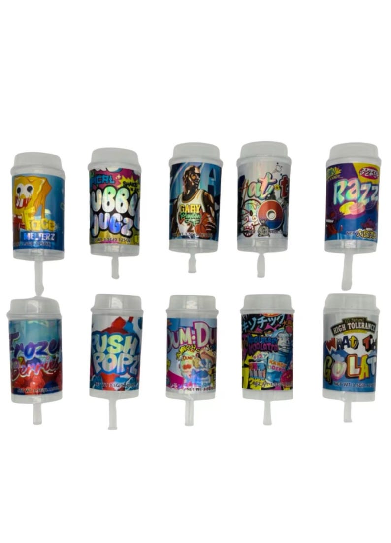 May include: A collection of ten cylindrical push pop containers with various colorful designs and text. The containers feature images of cartoon characters, basketball players, and graffiti-style art. Each container has a white lid and a clear plastic base.