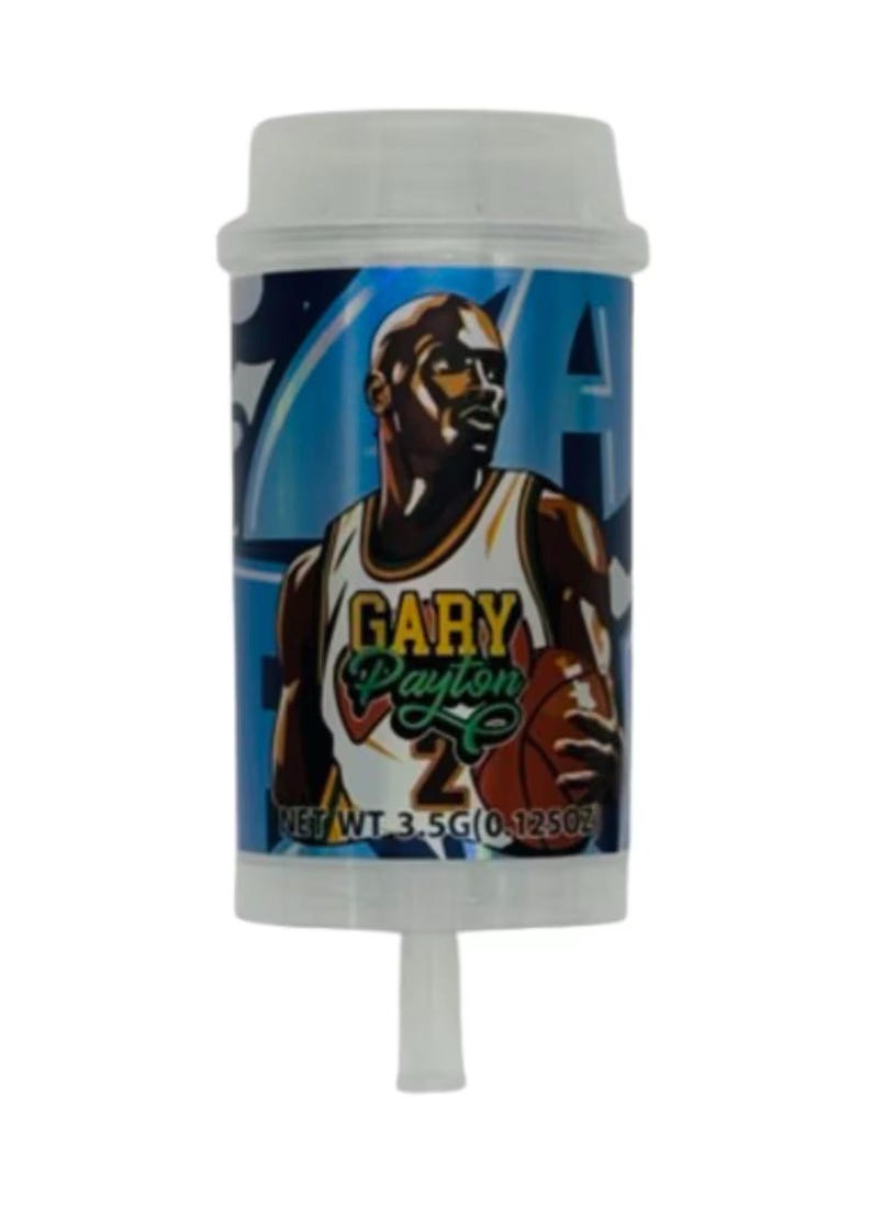 May include: A cylindrical container with a white cap and a clear, tapered bottom. The container features a blue background with an illustration of Gary Payton in a basketball uniform. Text on the container reads "GARY Payton" and "NET WT 3.5G (0.125OZ)".