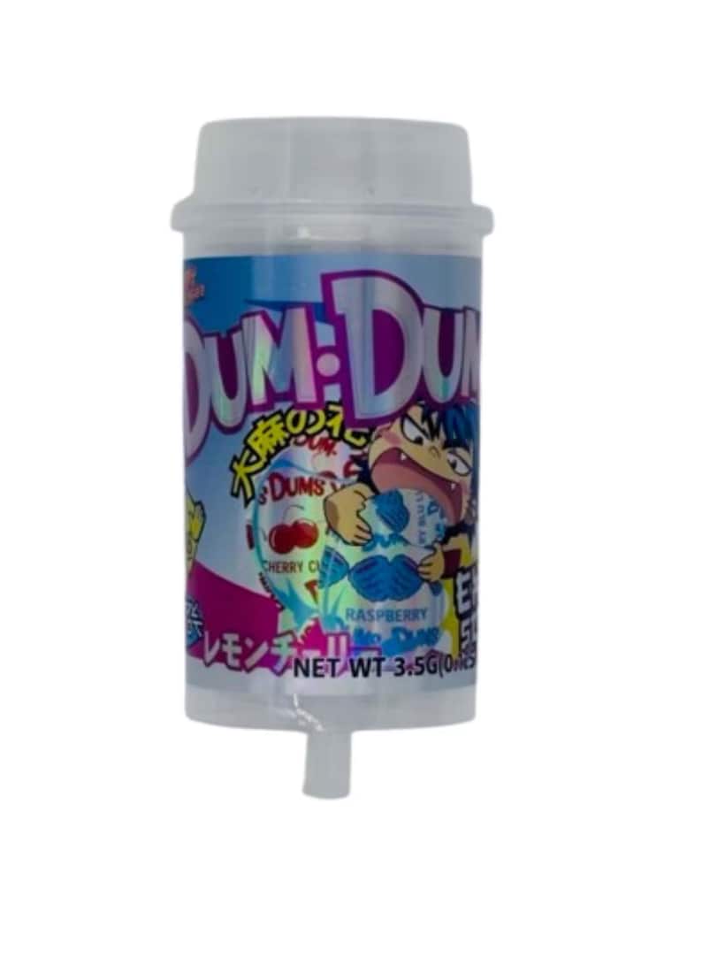 May include: A clear plastic container of Dum Dums candy. The label features a cartoon character and text in multiple languages, including "Cherry Cherry" and "Raspberry". The net weight is 3.5 oz.