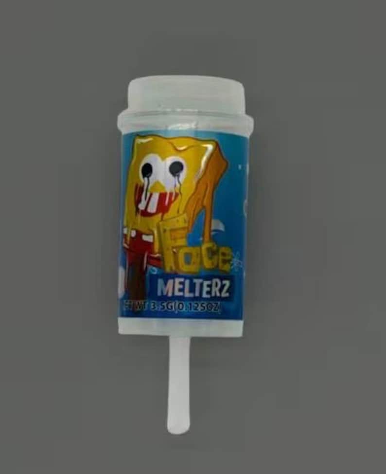 May include: A clear plastic container with a white lid and a white stick. The container has a blue label with a yellow SpongeBob SquarePants graphic and the text "FACE MELTERZ". Net wt 3.5g (0.125oz).