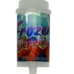 May include: A cylindrical container with a clear cap and base, featuring the text "Frozen Berries" in purple and red. The label shows illustrations of red and blue berries. The net weight is 0.125oz.