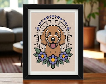 May include: A framed cross-stitch artwork featuring a brown dog with its tongue out, surrounded by purple flowers and a decorative arch. The artwork is set against a beige background and framed in a black frame.