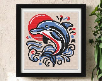 May include: Framed cross-stitch art featuring a blue dolphin leaping from blue and white waves, with a red sun in the background. The dolphin has red and white accents. The artwork is in a black frame.