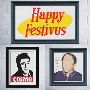 May include: Three framed cross-stitch patterns featuring characters and text from the TV show Seinfeld. The top frame has a yellow background with the text "Happy Festivus" in red. The left frame has a black and white portrait of a man with the text "COSMO" in red. The right frame has a portrait of a man with the text "It's not a lie if you believe it..." in black.